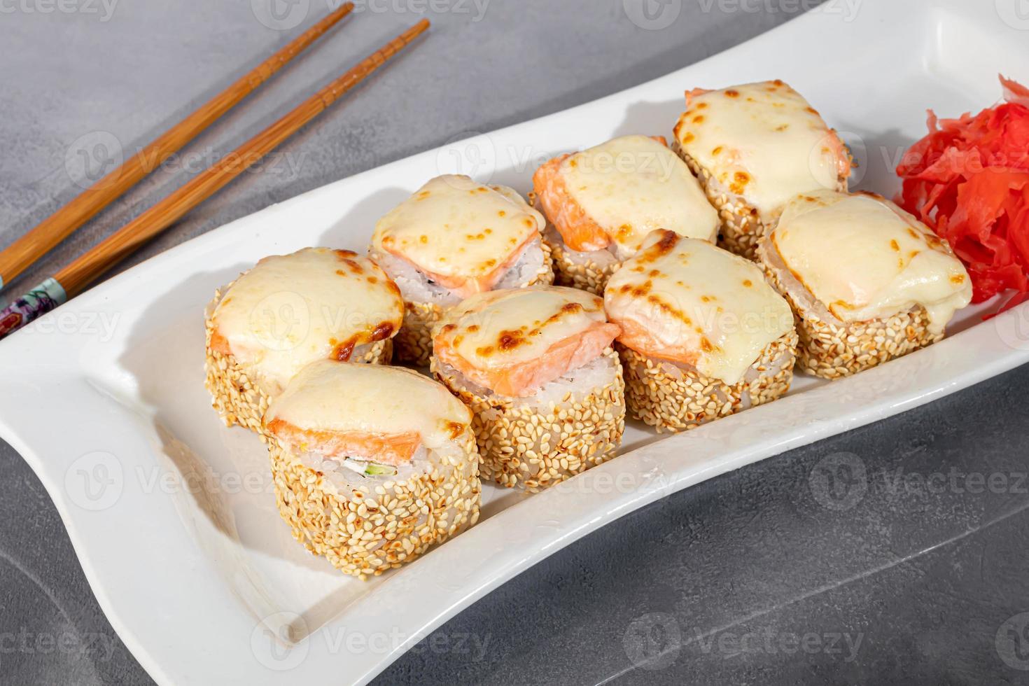 Sushi sets Uramaki, California, Philadelphia, rolls on a white plate. Menu for restaurants, cafes. On a dark reflective background. photo