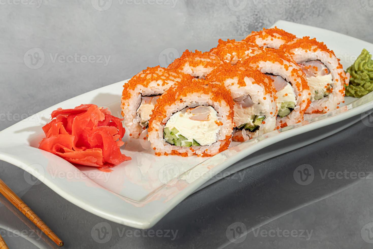 Sushi sets Uramaki, California, Philadelphia, rolls on a white plate. Menu for restaurants, cafes. On a dark reflective background. photo
