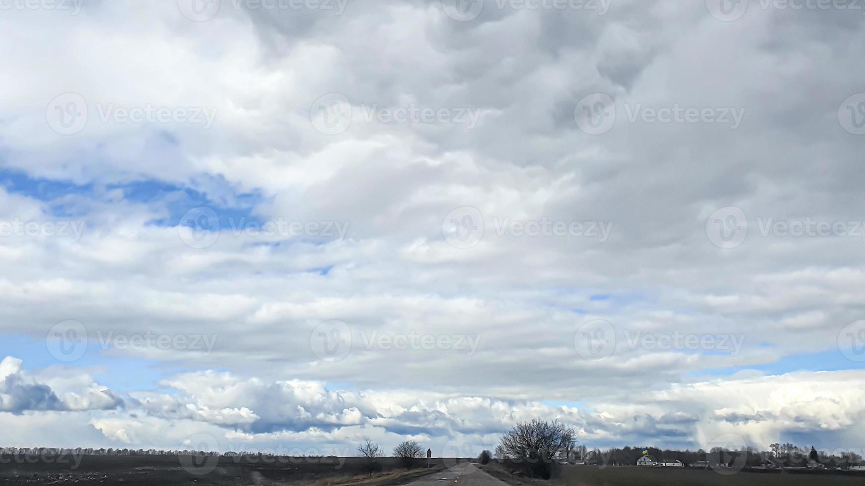 Blue sky with clouds. Road, exit from the occupied territories. War in Ukraine. Escape from the aggressor. photo