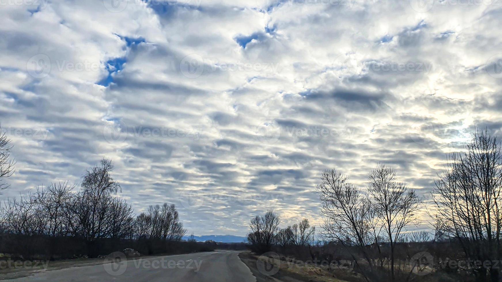 Blue sky with clouds. Road, exit from the occupied territories. War in Ukraine. Escape from the aggressor. photo