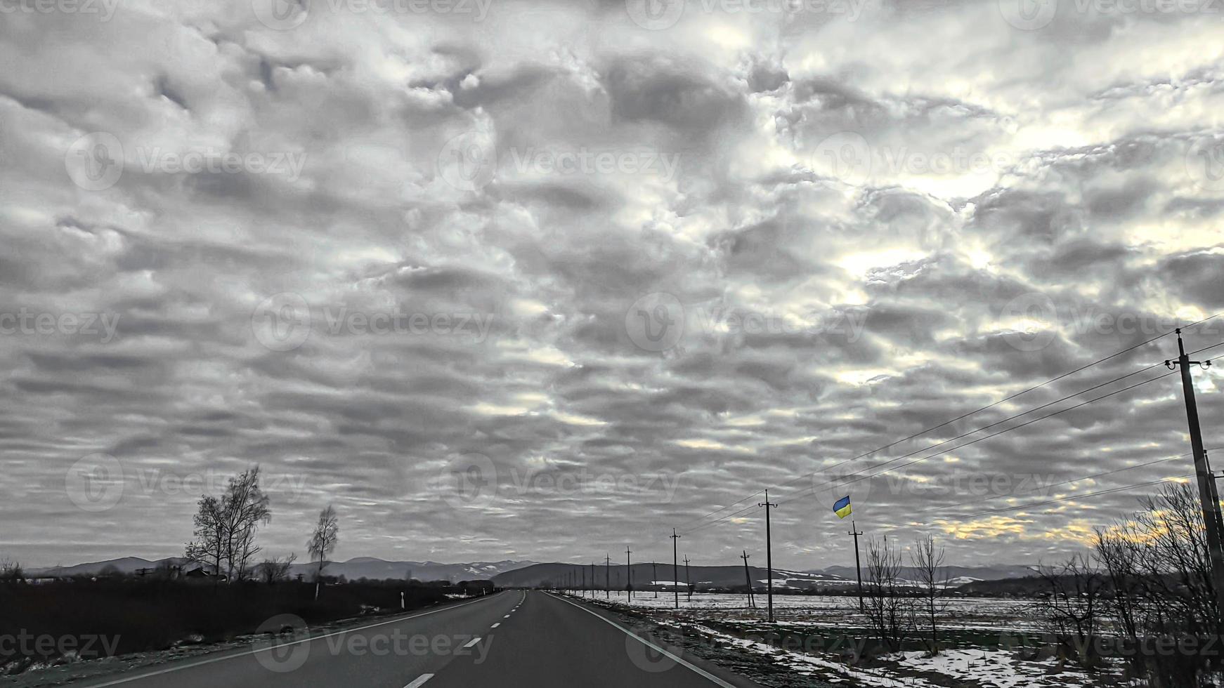 Blue sky with clouds. Road, exit from the occupied territories. War in Ukraine. Escape from the aggressor. photo