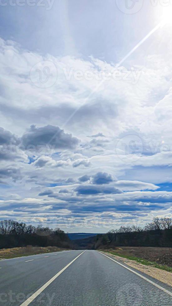 Blue sky with clouds. Road, exit from the occupied territories. War in Ukraine. Escape from the aggressor. photo