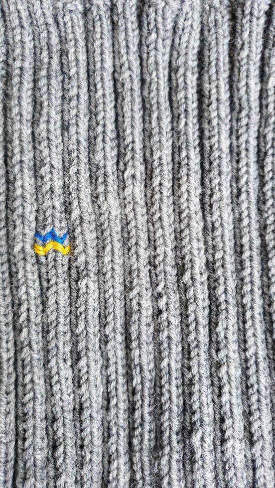 Handmade balaclava with Ukrainian symbols. Knitted from gray and green threads. Warms, reliably saves from the cold. photo