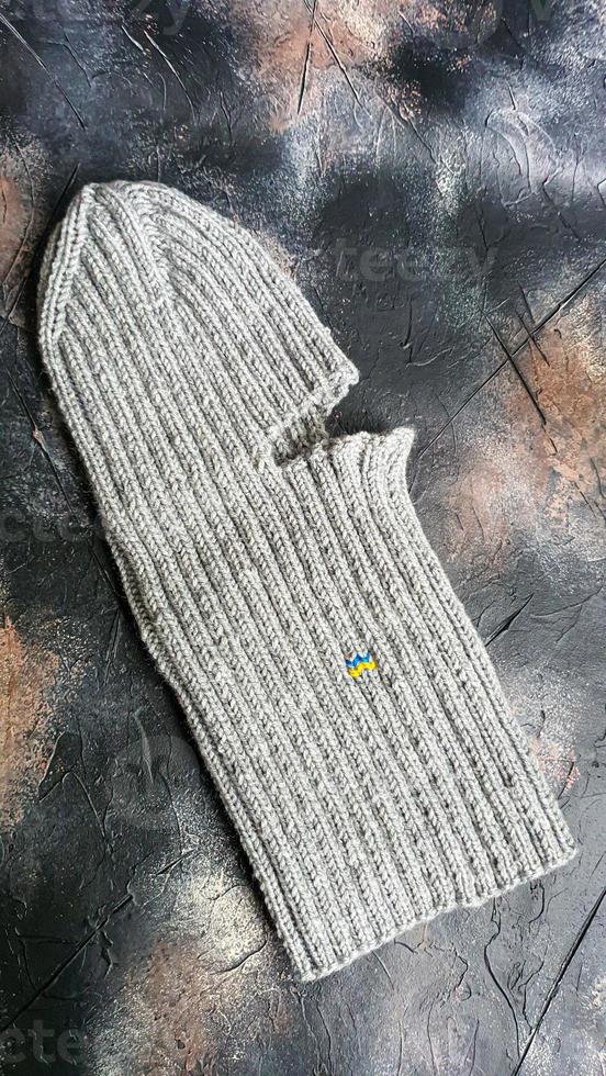 Handmade balaclava with Ukrainian symbols. Knitted from gray and green threads. Warms, reliably saves from the cold. photo