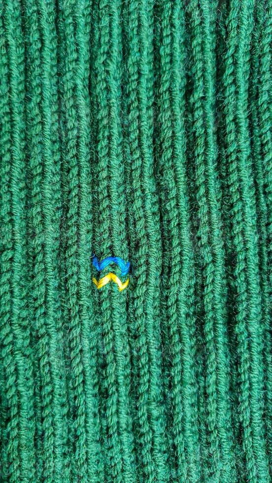 Handmade balaclava with Ukrainian symbols. Knitted from gray and green threads. Warms, reliably saves from the cold. photo