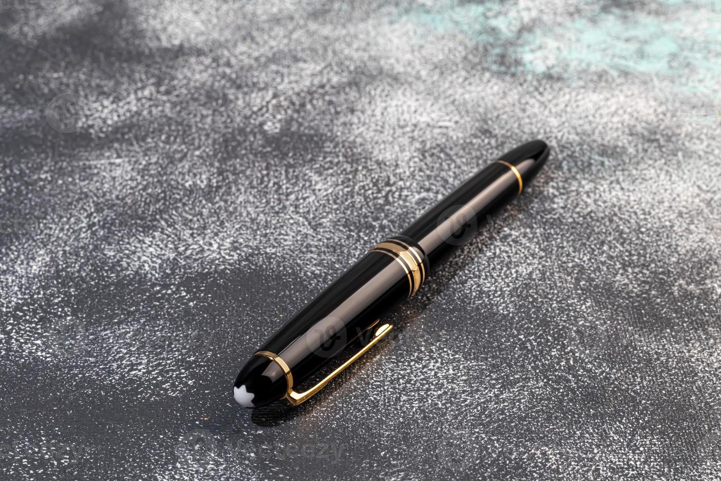 Fountain pen on a marble and gray background. Selective focus. photo