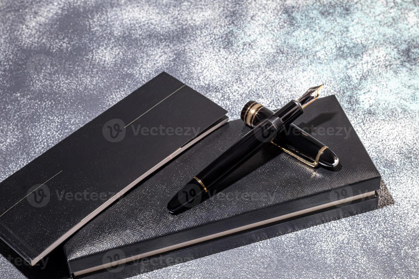 Fountain pen on a marble and gray background. Selective focus. photo