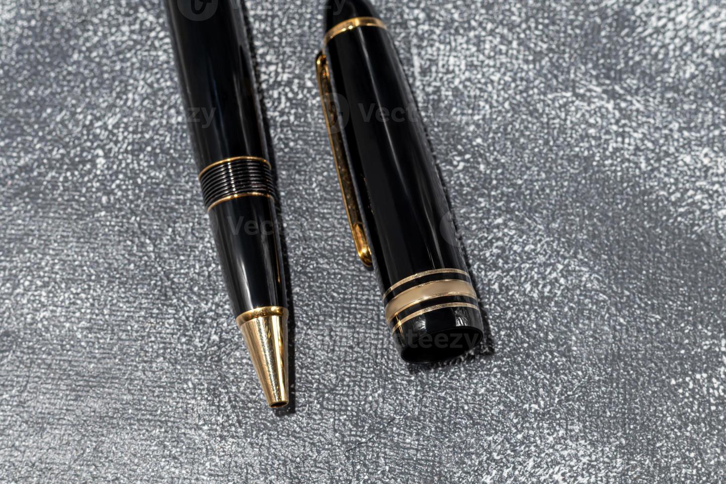 Fountain pen on a marble and gray background. Selective focus. photo