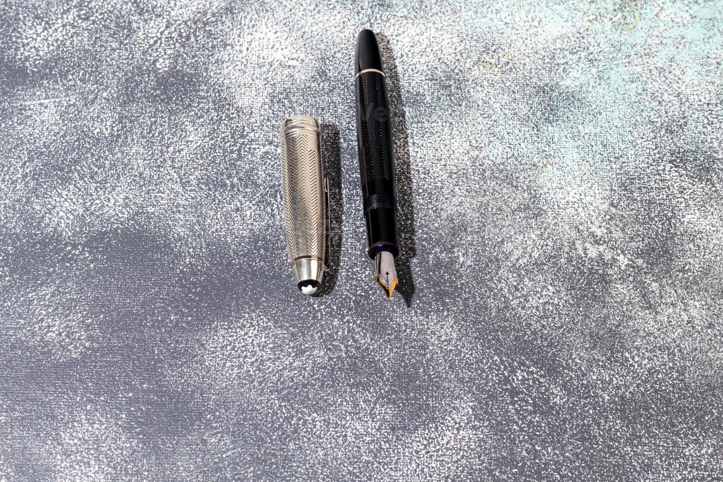 Fountain pen on a marble and gray background. Selective focus. photo