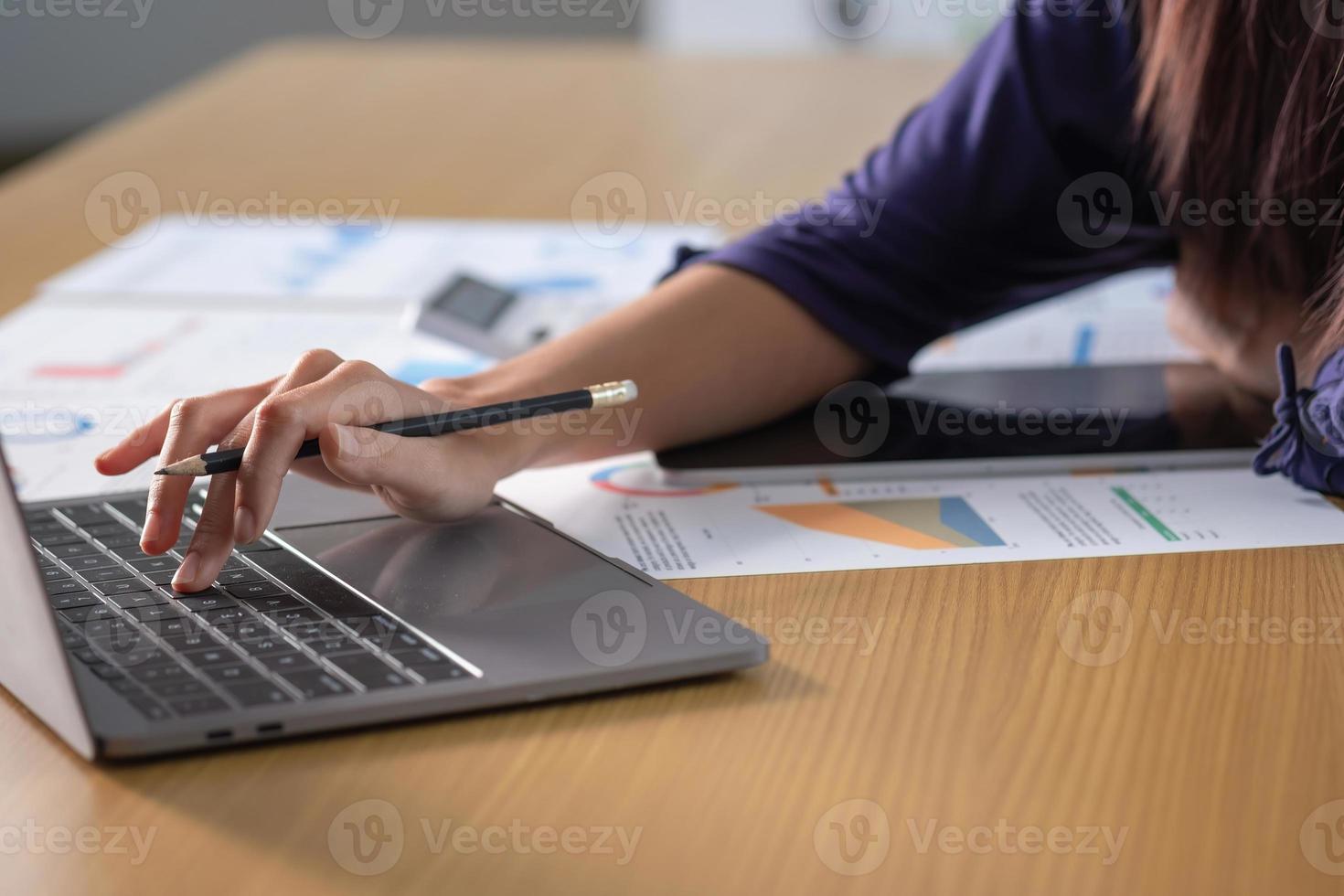 Marketing, Financial, Accounting, Planning, Team of business women analyze company results and profits with graph statistics. Use a laptop computer and a calculator to calculate the company's balance. photo