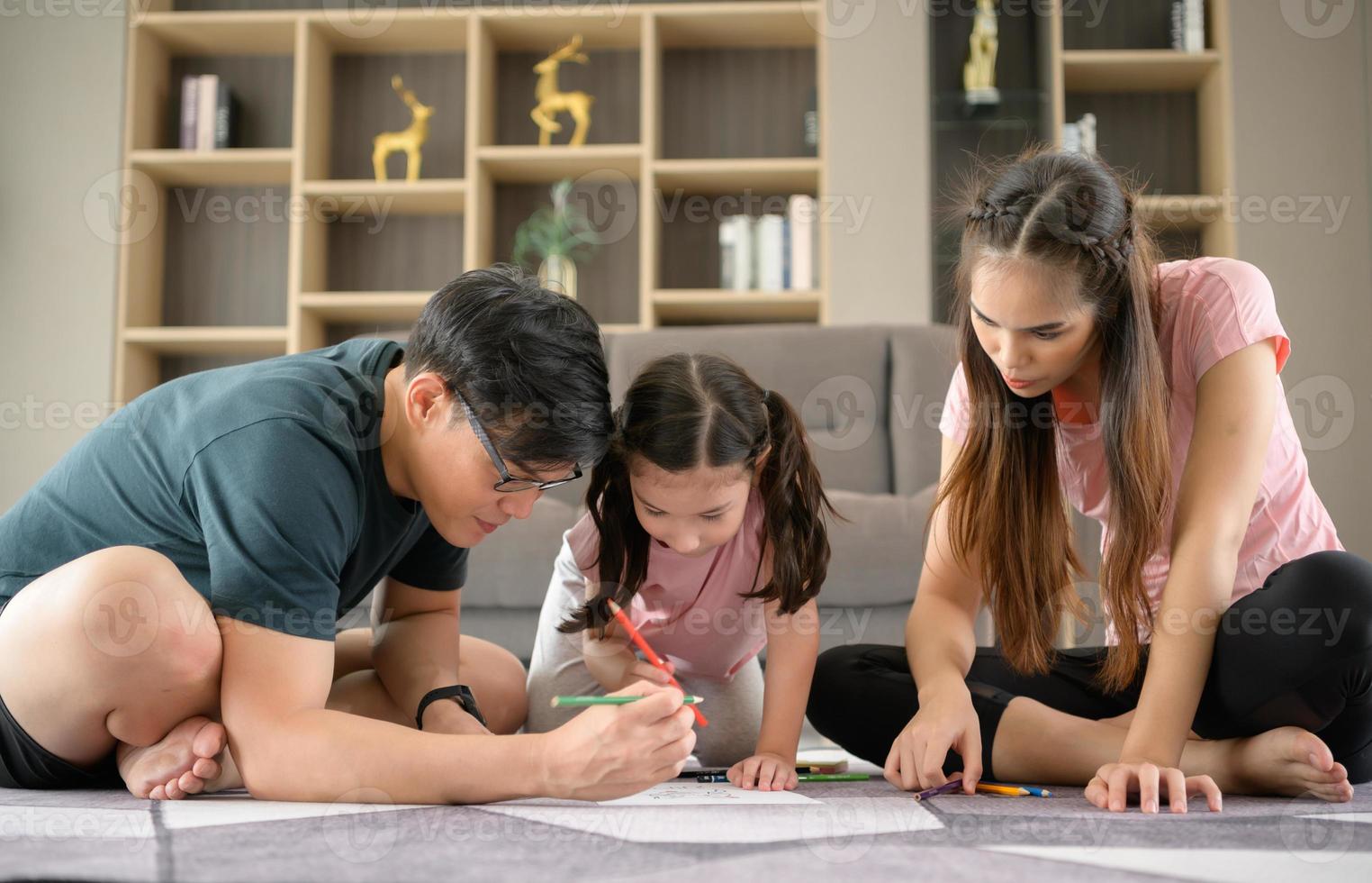 Family holiday activities where parents and children play together happily in the living room of the house. photo