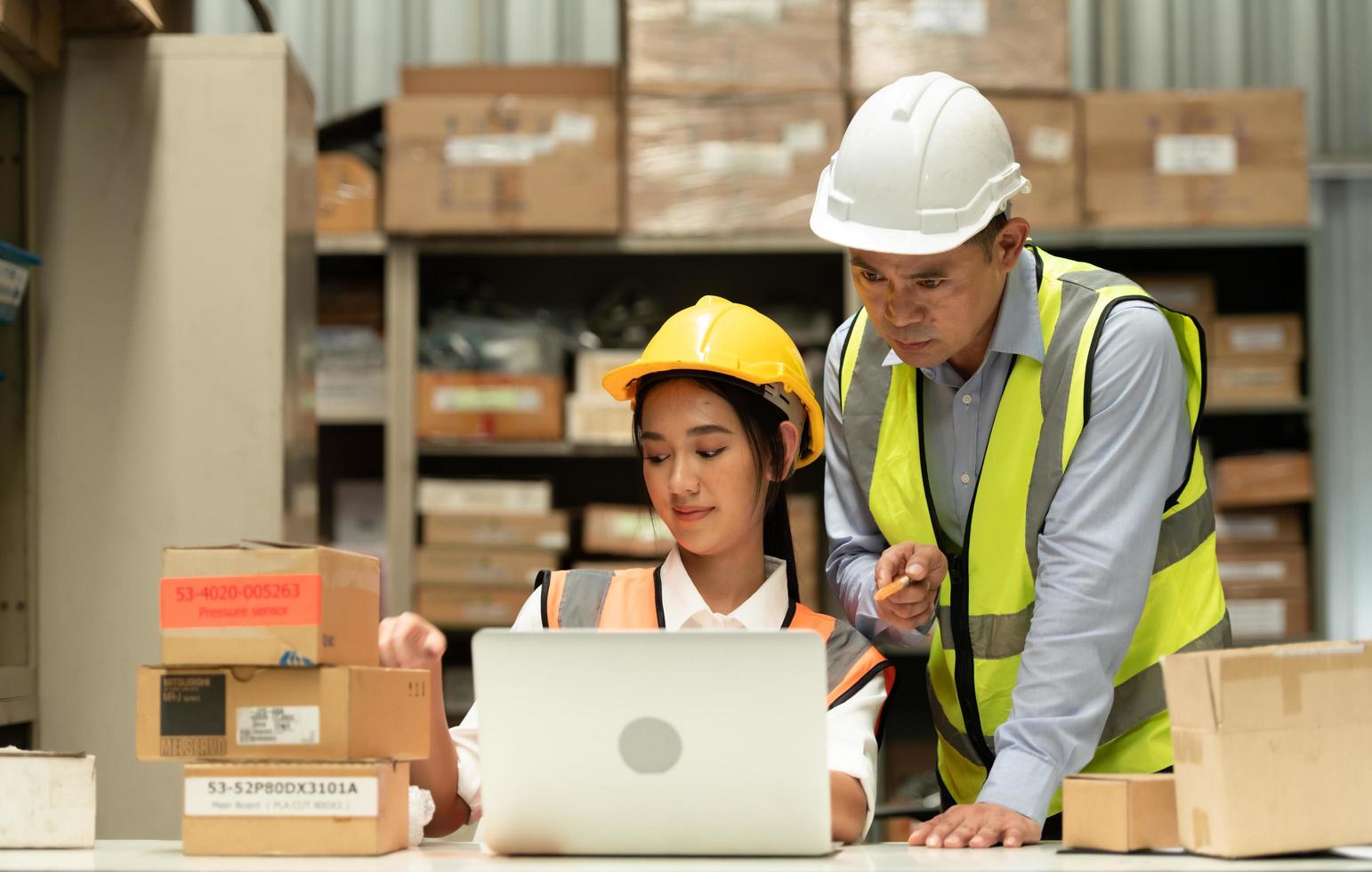 Warehouse Manager with female assistant Rethink a plan to prepare items that need to be sold to retailers during times of higher market prices. photo