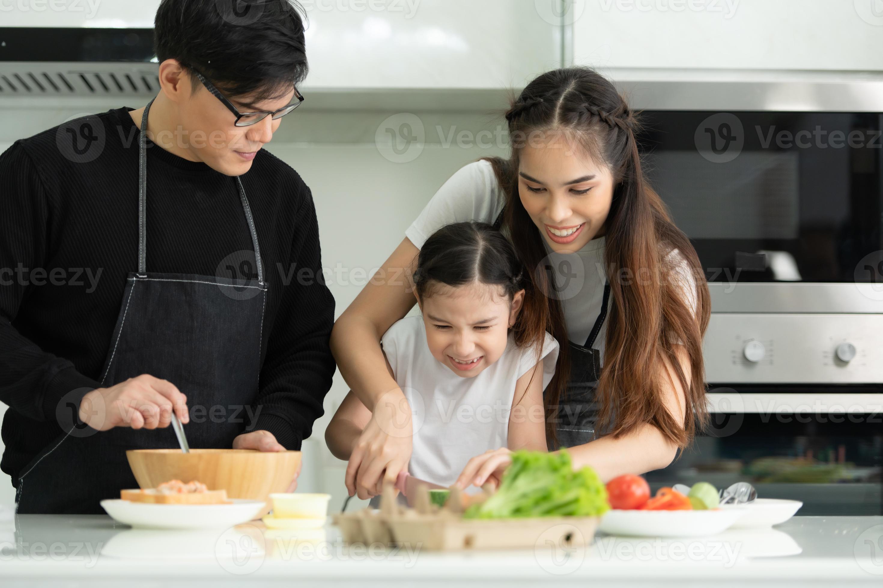 Asian family is cooking in the kitchen together