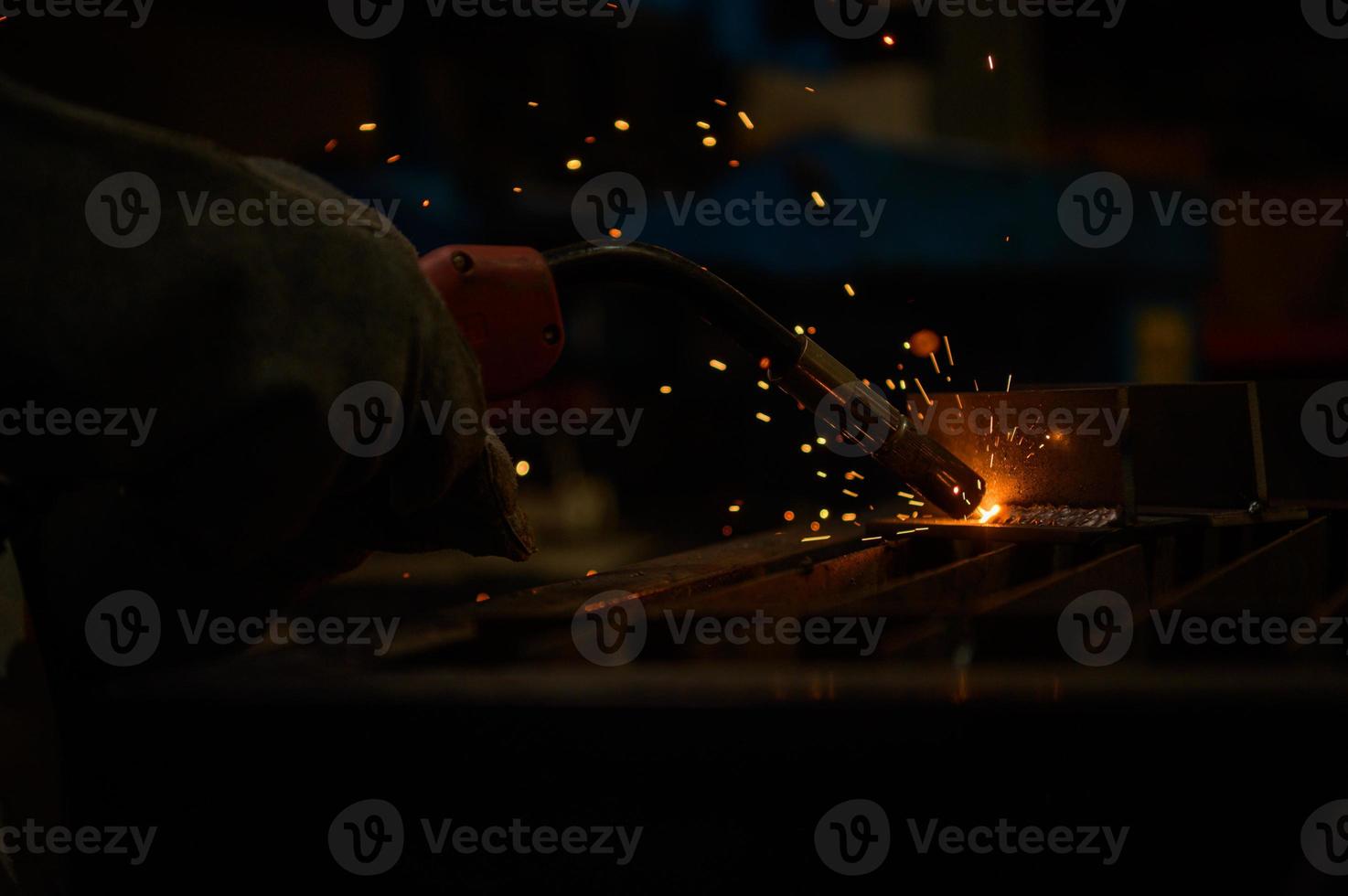 A welder is working to weld metal. to create quality work according to the prescribed form photo