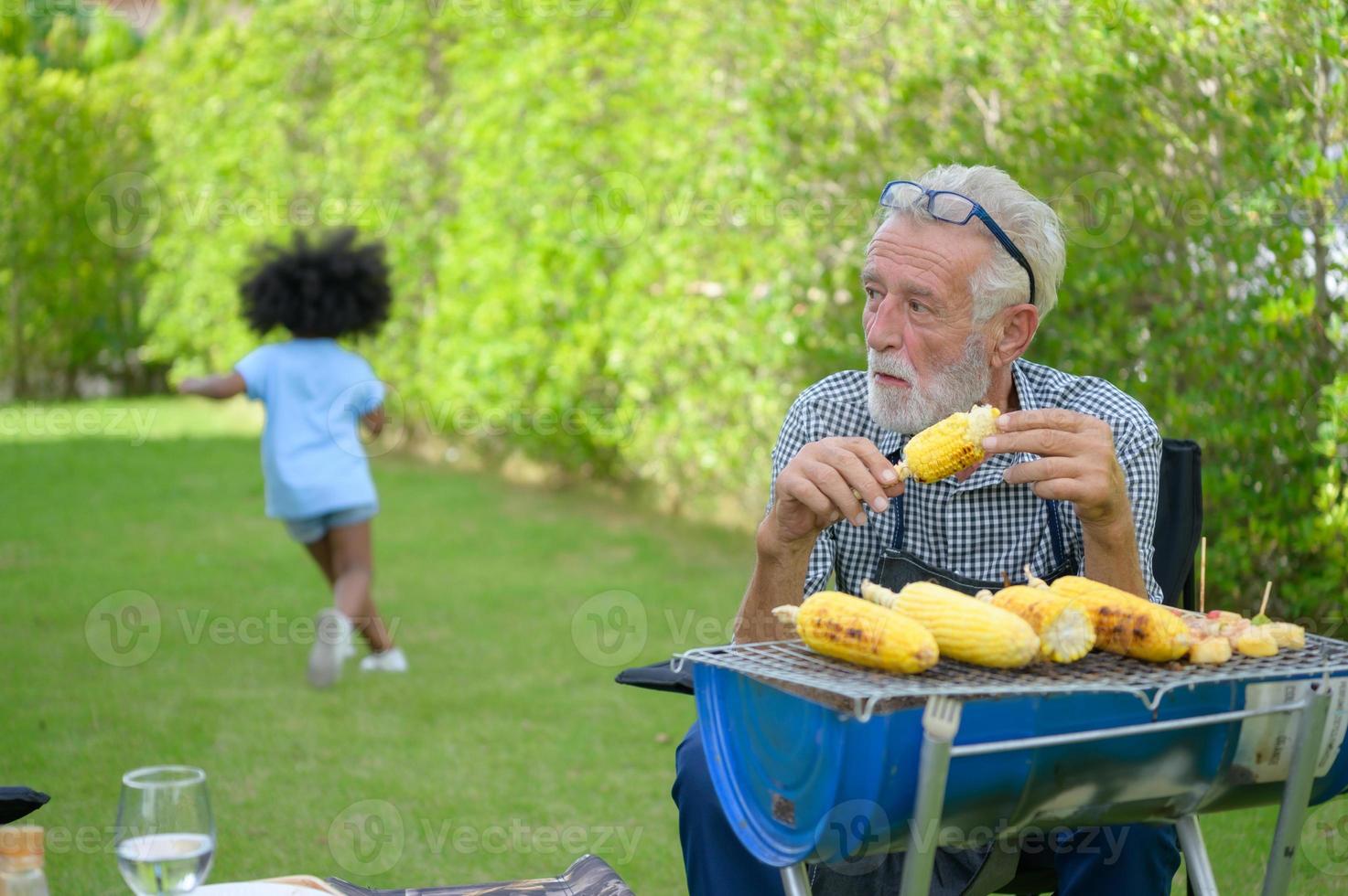 Family holiday activities with grandfather, mother and children with camping. bbq grill and play in the yard together happily on vacation. photo