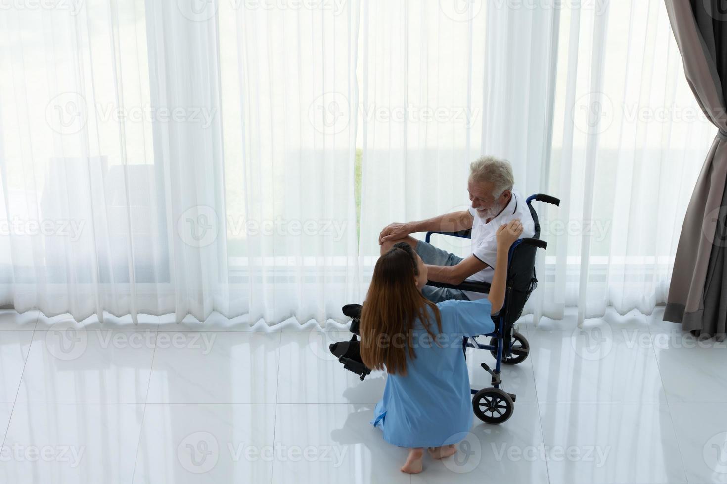 Doctor talking to elderly patient with symptoms of depression Look at nature outside the window in a special patient room. photo