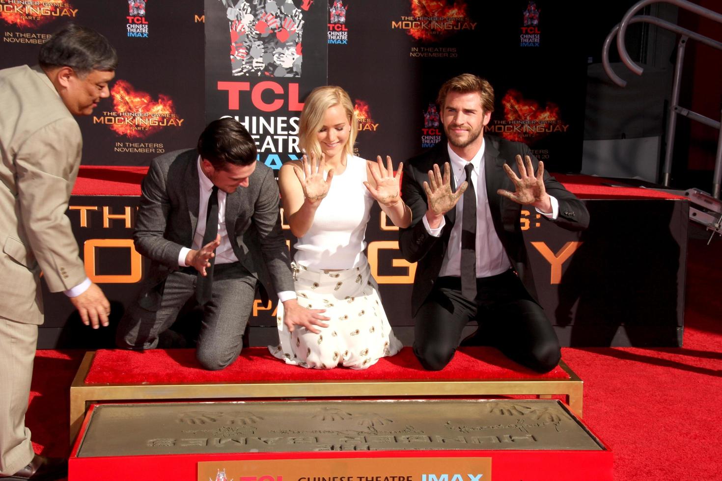 LOS ANGELES, OCT 31 -  Josh Hutcherson, Jennifer Lawrence, Liam Hemsworth at the Hunger Games Handprint and Footprint Ceremony at the TCL Chinese Theater on October 31, 2015 in Los Angeles, CA photo
