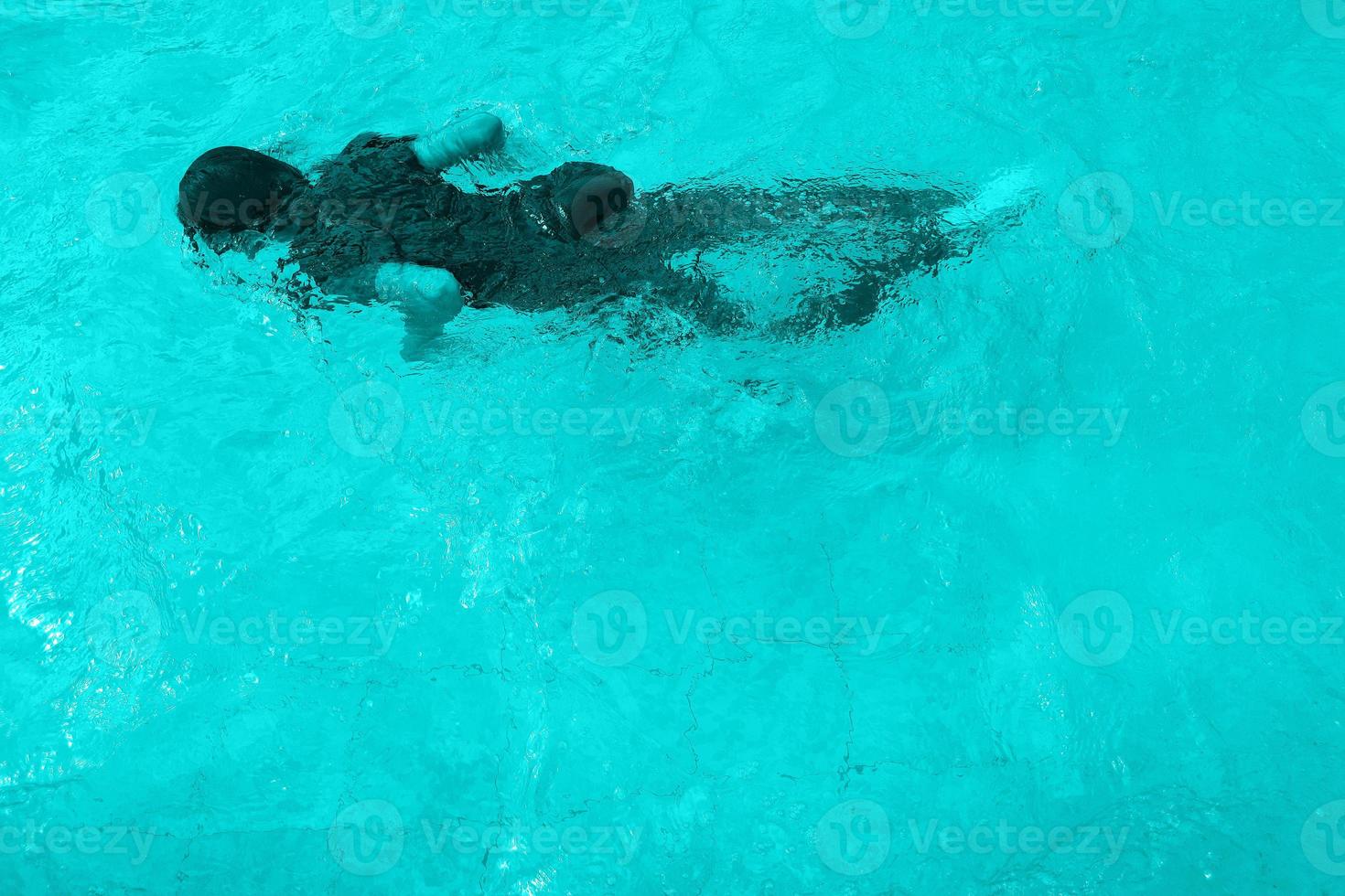Defocus blurred blue watercolor in swimming pool rippled water detail background. Water splash, water spray background. photo