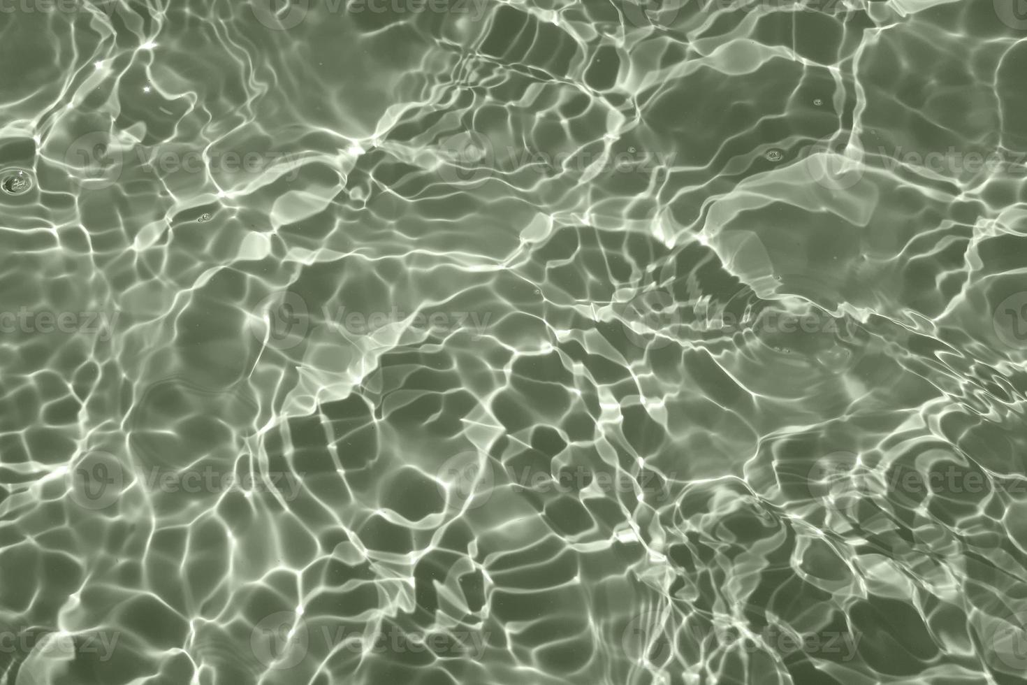 Defocus blurred blue water in swimming pool rippled water detail background. Water surface in the sea, ocean background. Water is an inorganic, transparent, tasteless, odorless, and nearly colorless. photo