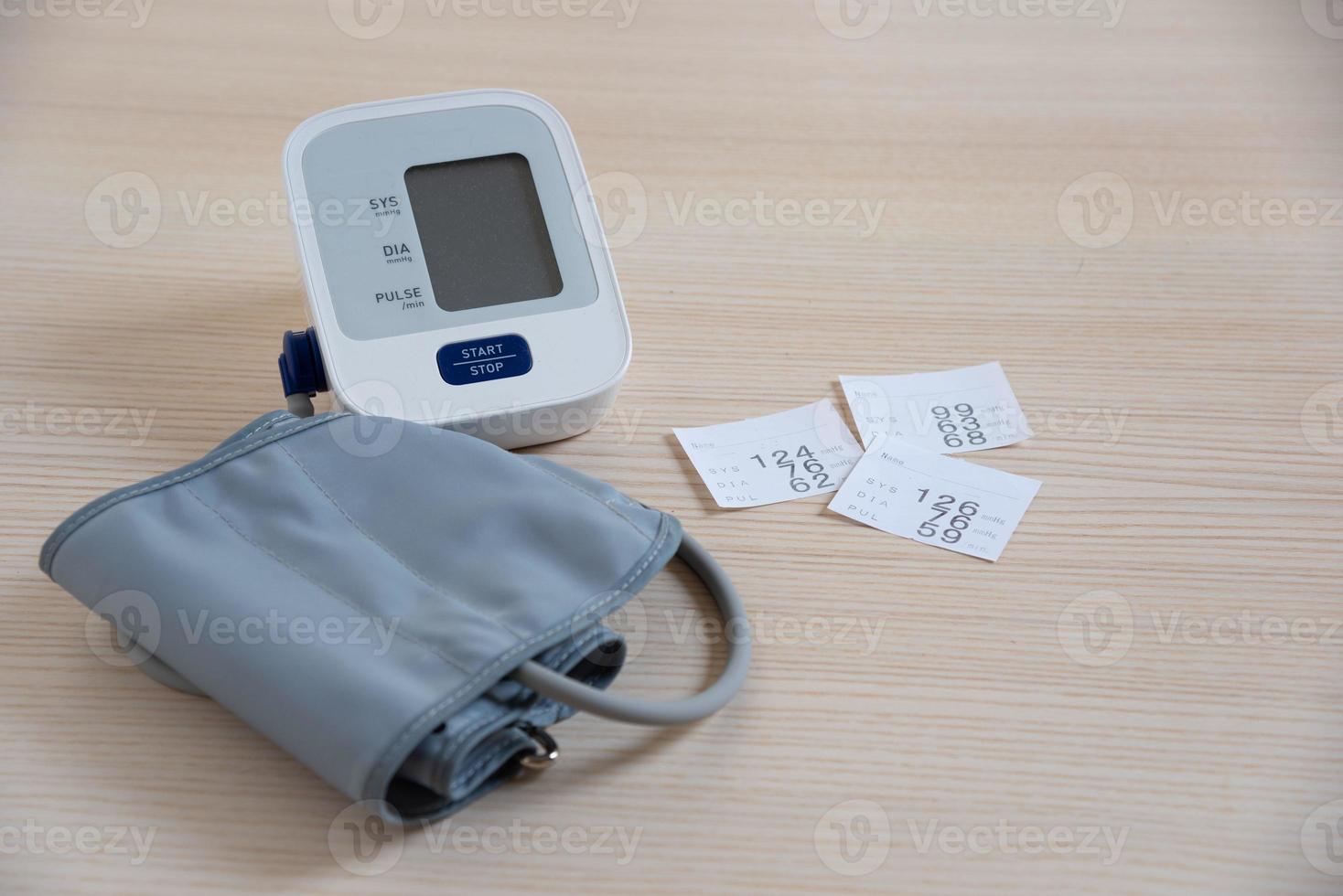 Paper showing blood pressure and a sphygmomanometer photo