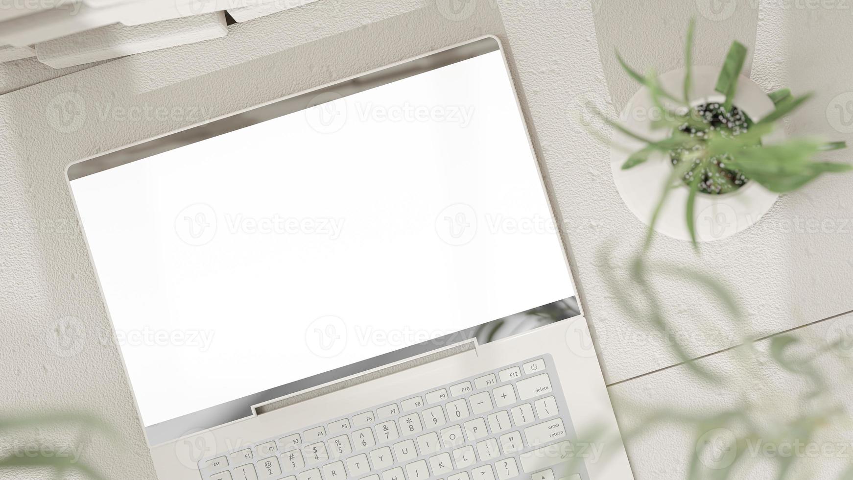 Laptop Mock-Up Empty screen on cement floor front white brick wall High angle shot. shadow of tree and window. Decorate minimalist style. photo