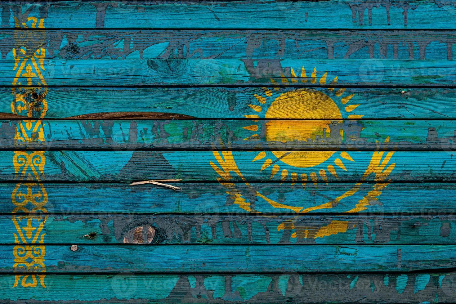 The national flag of Kazakhstan  is painted on uneven boards. Country symbol. photo