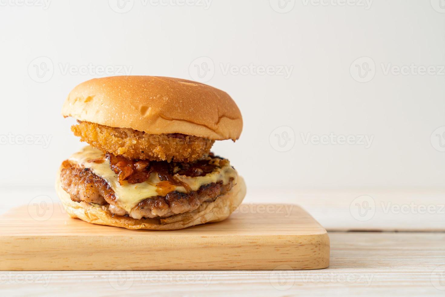 pork burger with cheese, bacon and onion rings photo