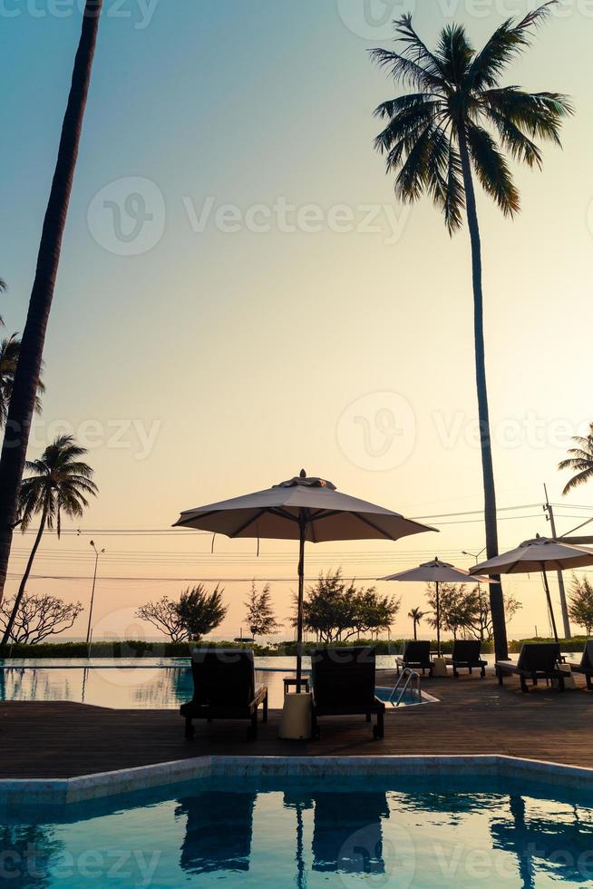 umbrella with bed pool around swimming pool with ocean sea background