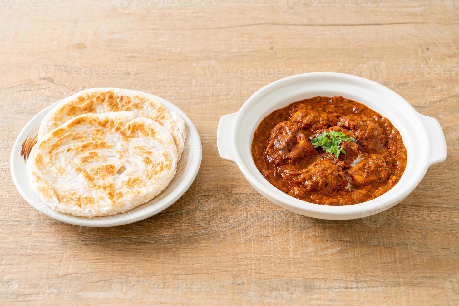 chicken tikka masala spicy curry meat food with roti or naan bread photo