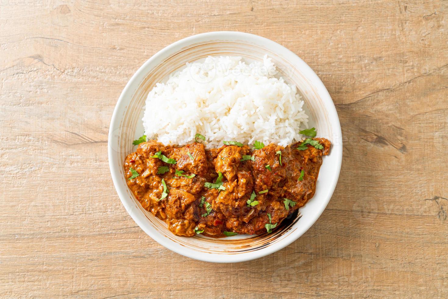 chicken tikka masala with rice on plate photo