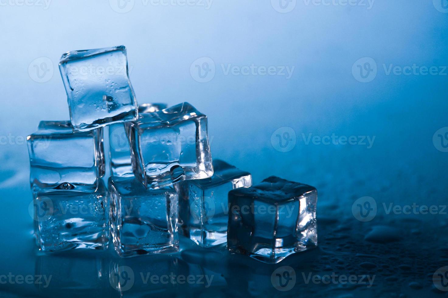 Ice cubes on studio blue background. The concept of freshness with coolness from ice cubes. photo