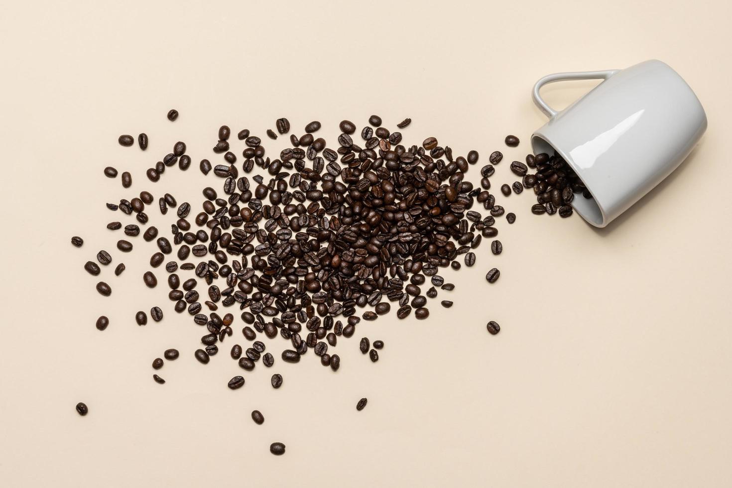 Coffee beans and white cup on coloured background photo