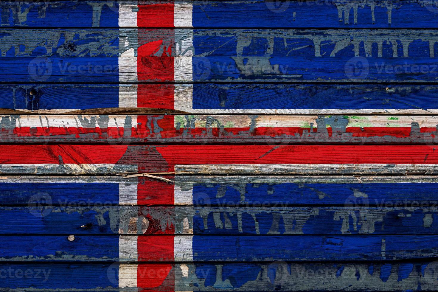 The national flag of Iceland  is painted on uneven boards. Country symbol. photo