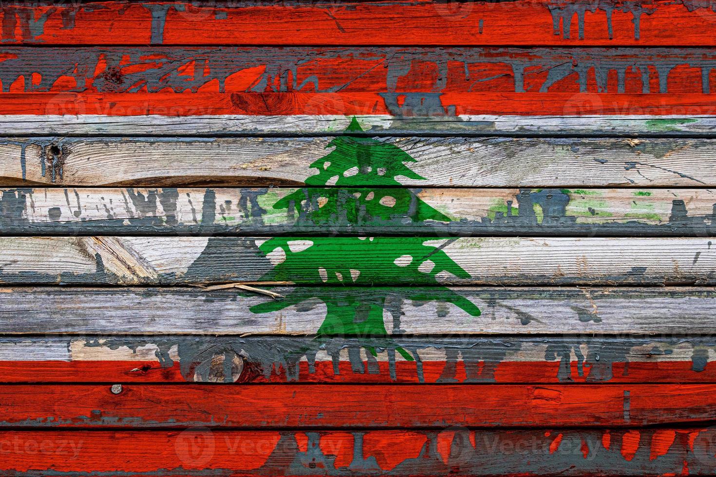 The national flag of Lebanon  is painted on uneven boards. Country symbol. photo