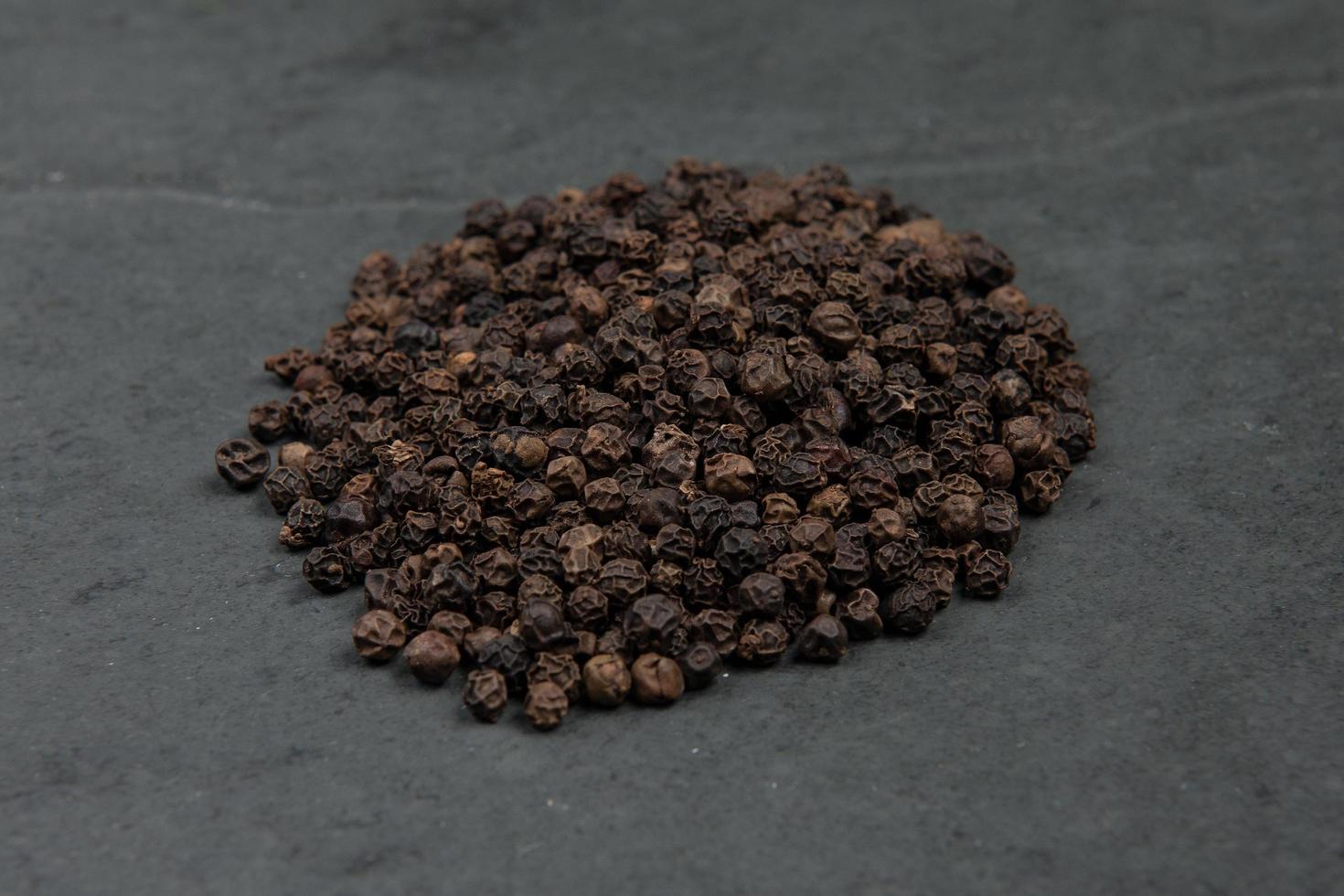 Pepper corns on table photo