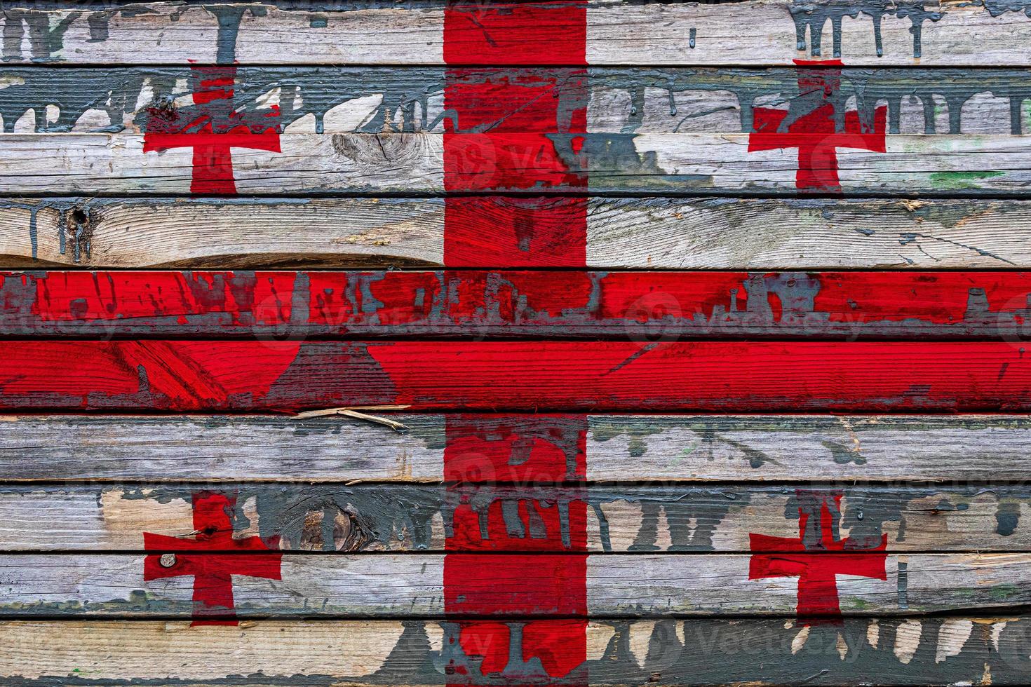 The national flag of Georgia is painted on uneven boards. Country symbol. photo