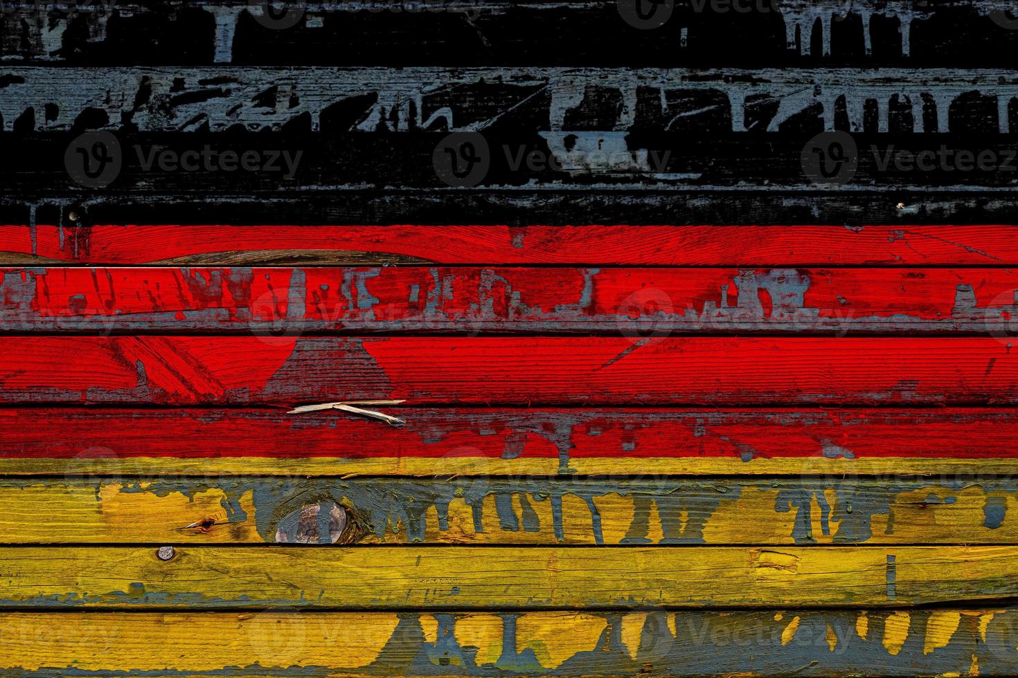 The national flag of Germany is painted on uneven boards. Country symbol. photo