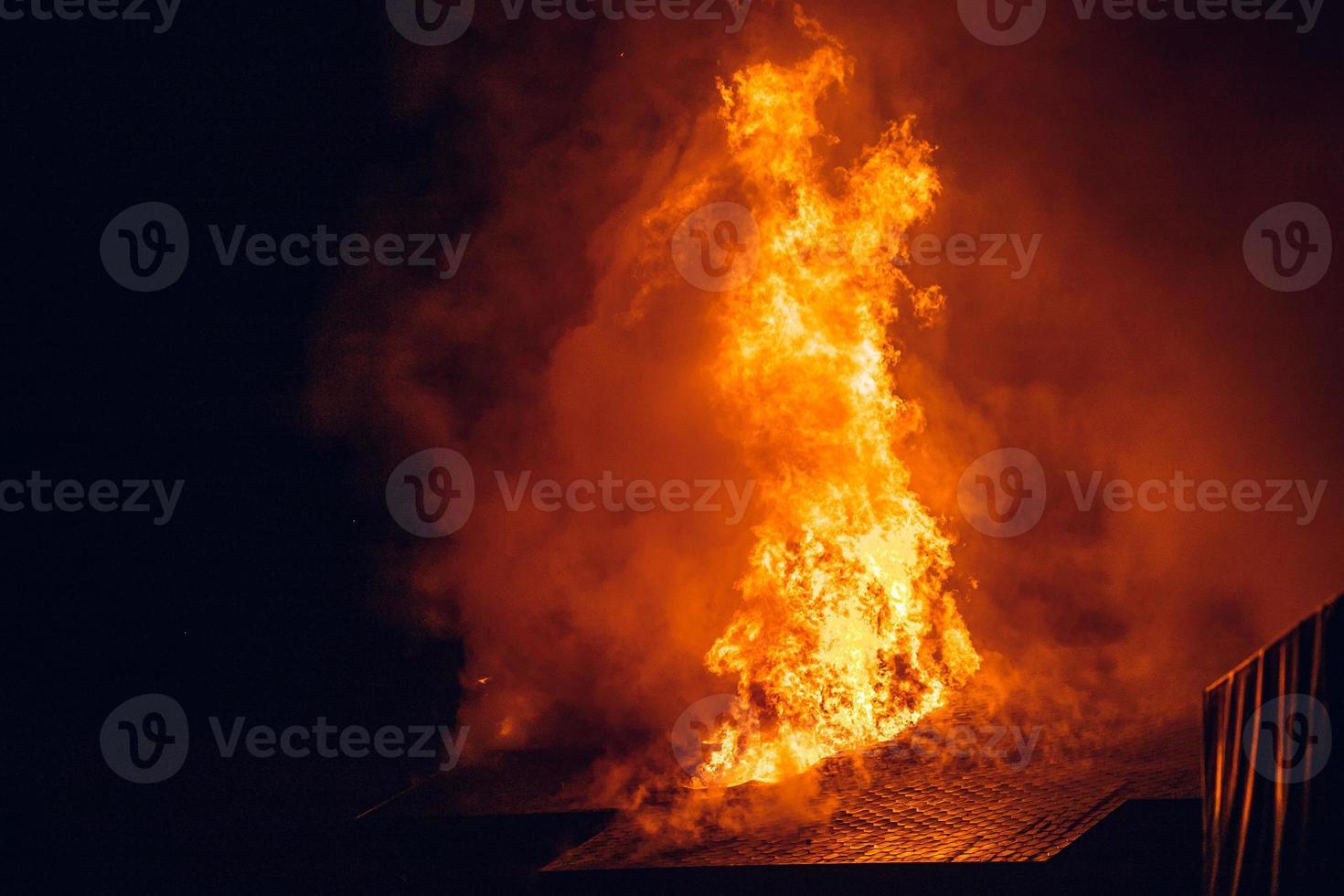 House on fire at night. Topics of arson and fires, disasters and extreme events. photo