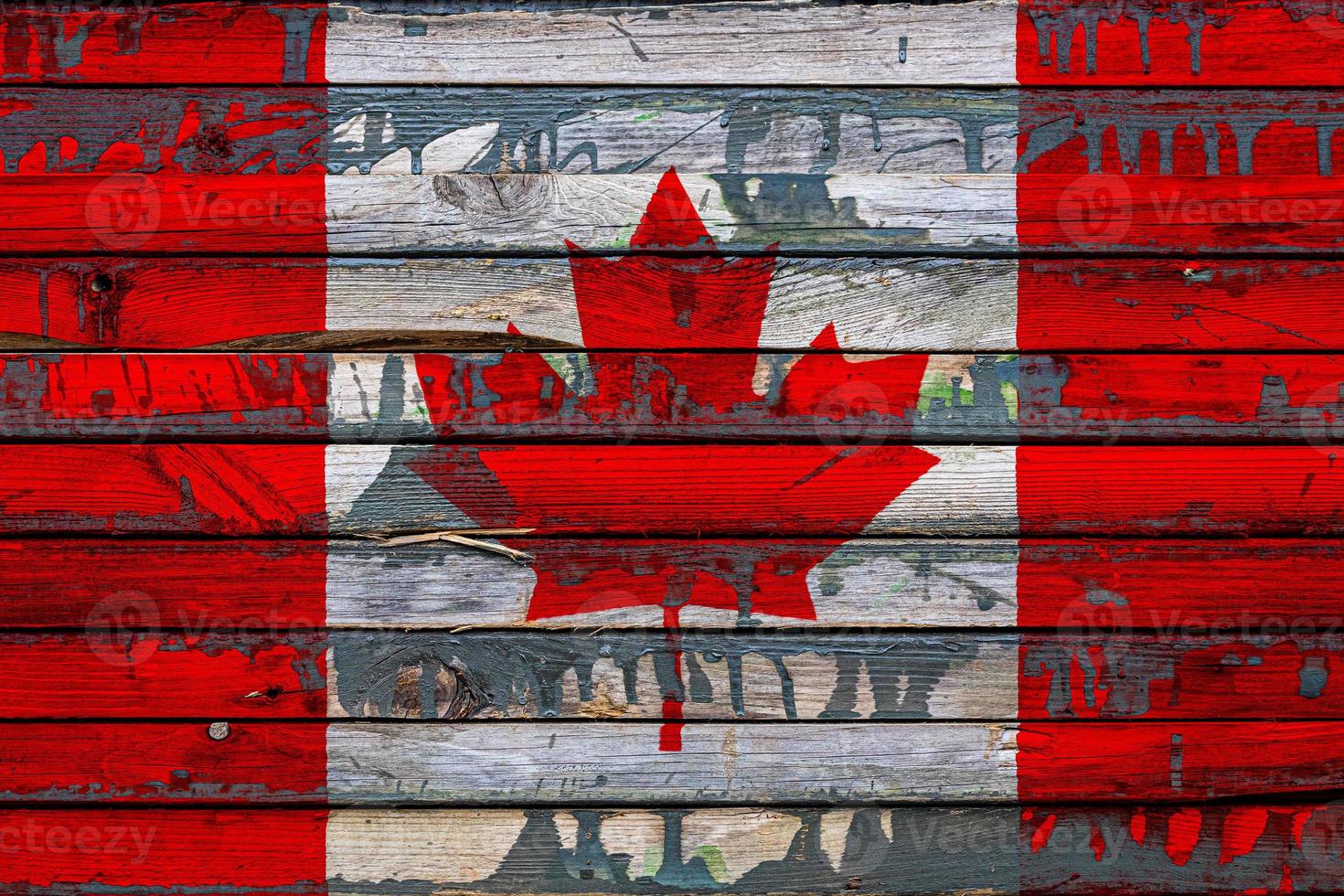 The national flag of Canada is painted on uneven boards. Country symbol. photo