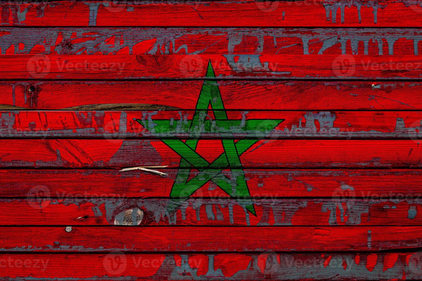 The national flag of Morocco is painted on uneven boards. Country symbol. photo