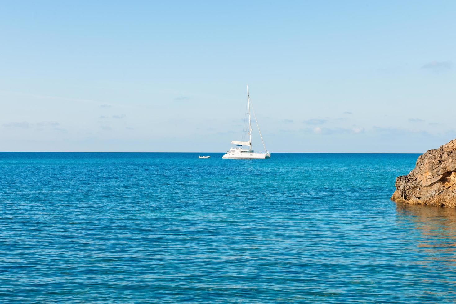 Sailboat on blue ocean photo