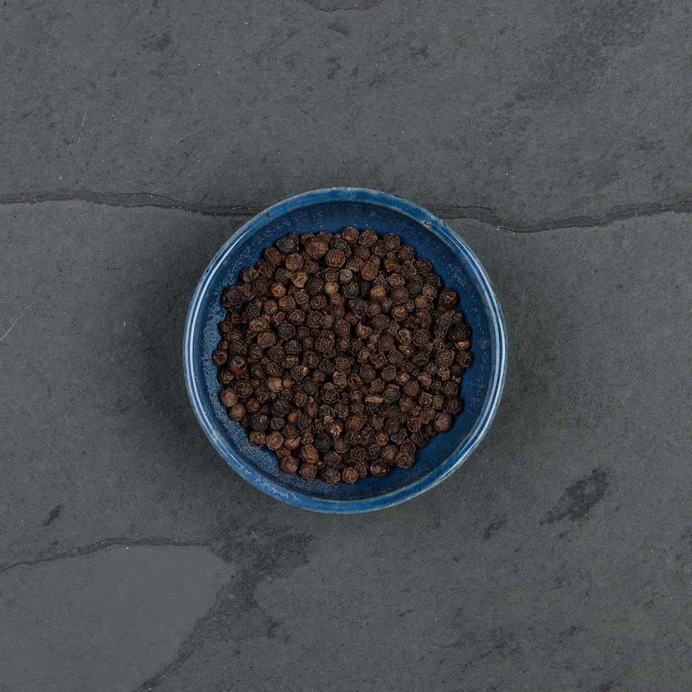 Pepper corns in a blue bowl photo