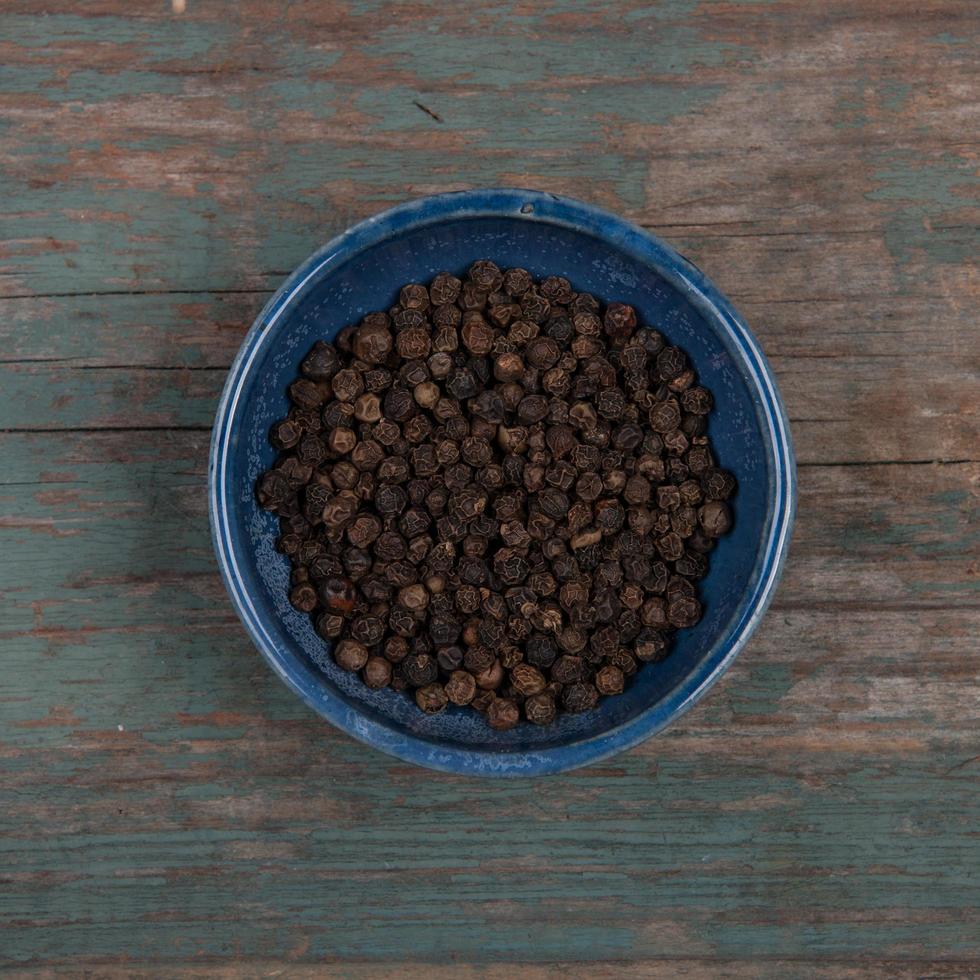 Pepper corns in a blue bowl photo
