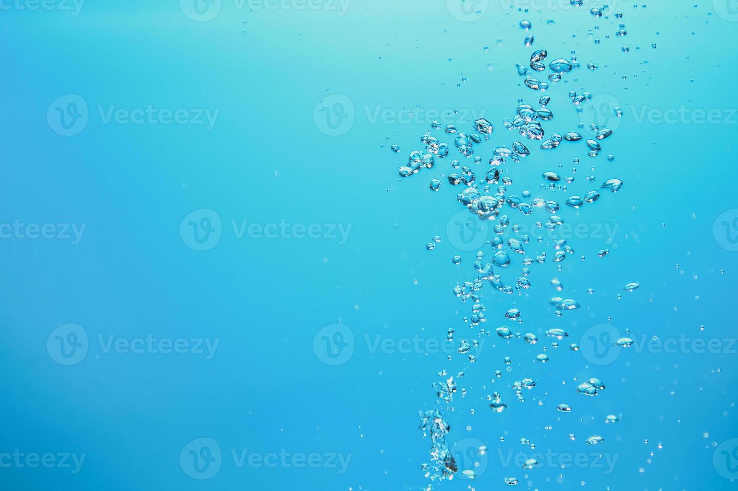 Abstract background image of bubbles in water. Clean water with water droplets and waves. Fresh water a glass with bubbles blue background. photo