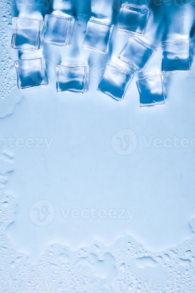 Ice cubes on studio blue background. The concept of freshness with coolness from ice cubes. photo