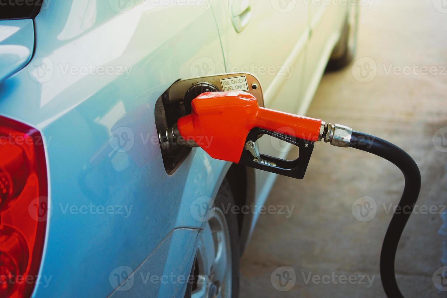 Gas station nozzles. Cars that are refueling in the gas station. The concept of fuel prices has changed. photo