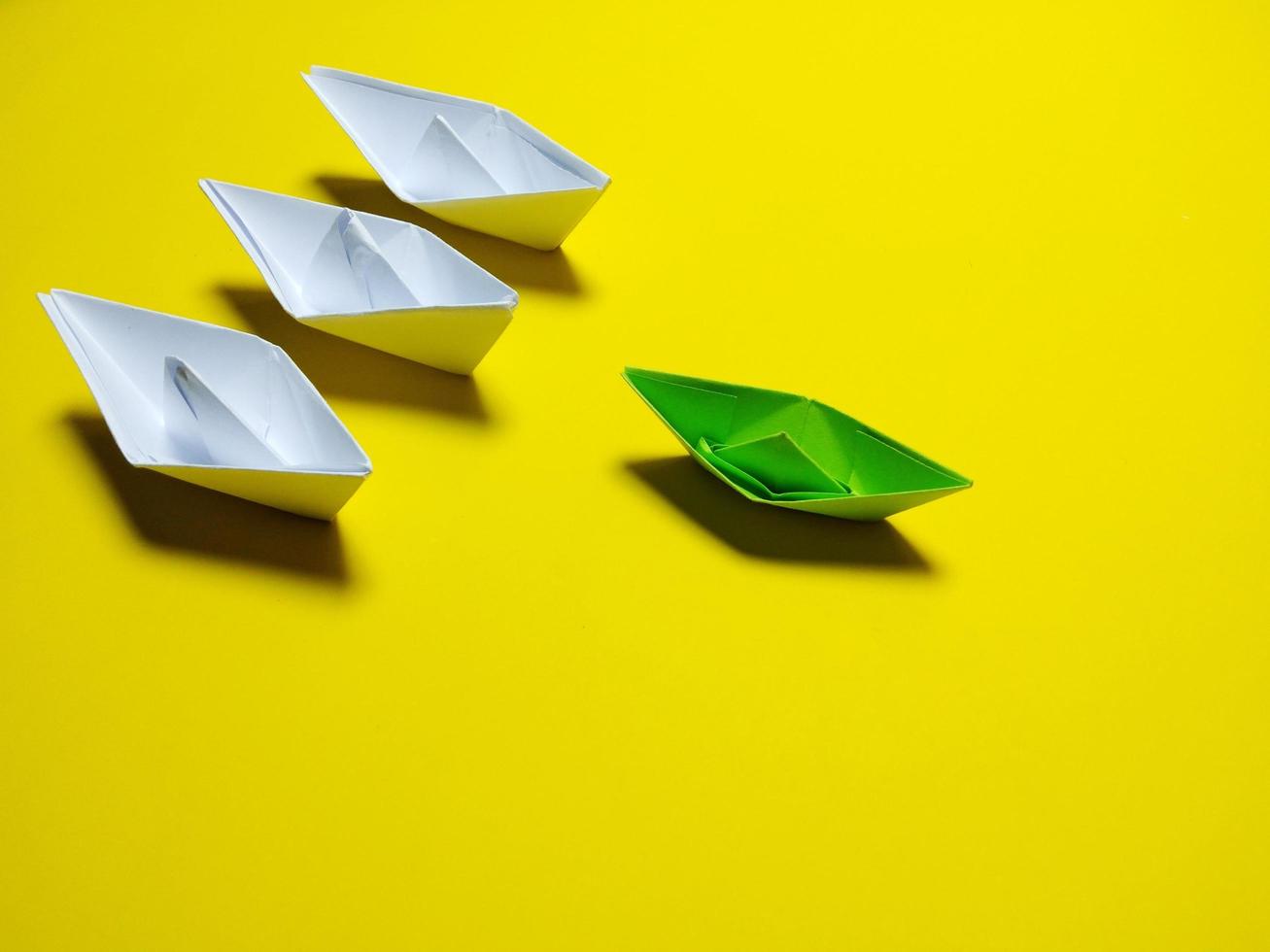 white and green paper boat yellow background in an orderly manner, providing ideas, leadership and effective management give a feeling have solidarity success, love, happiness, great photo
