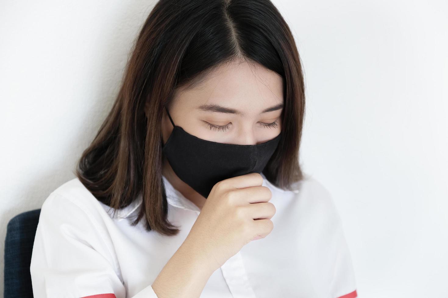 A young woman shows a cough that may be caused by a coronavirus infection. photo