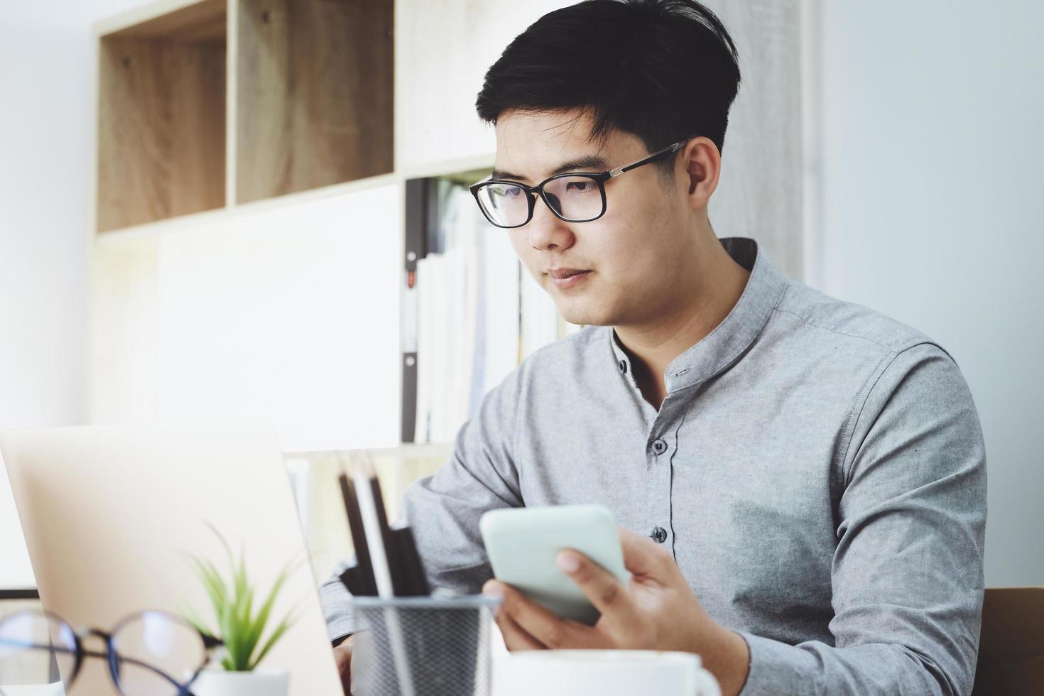 Business men are using their mobile phones to connect with their partners to talk about adjusting their profitable strategies. photo