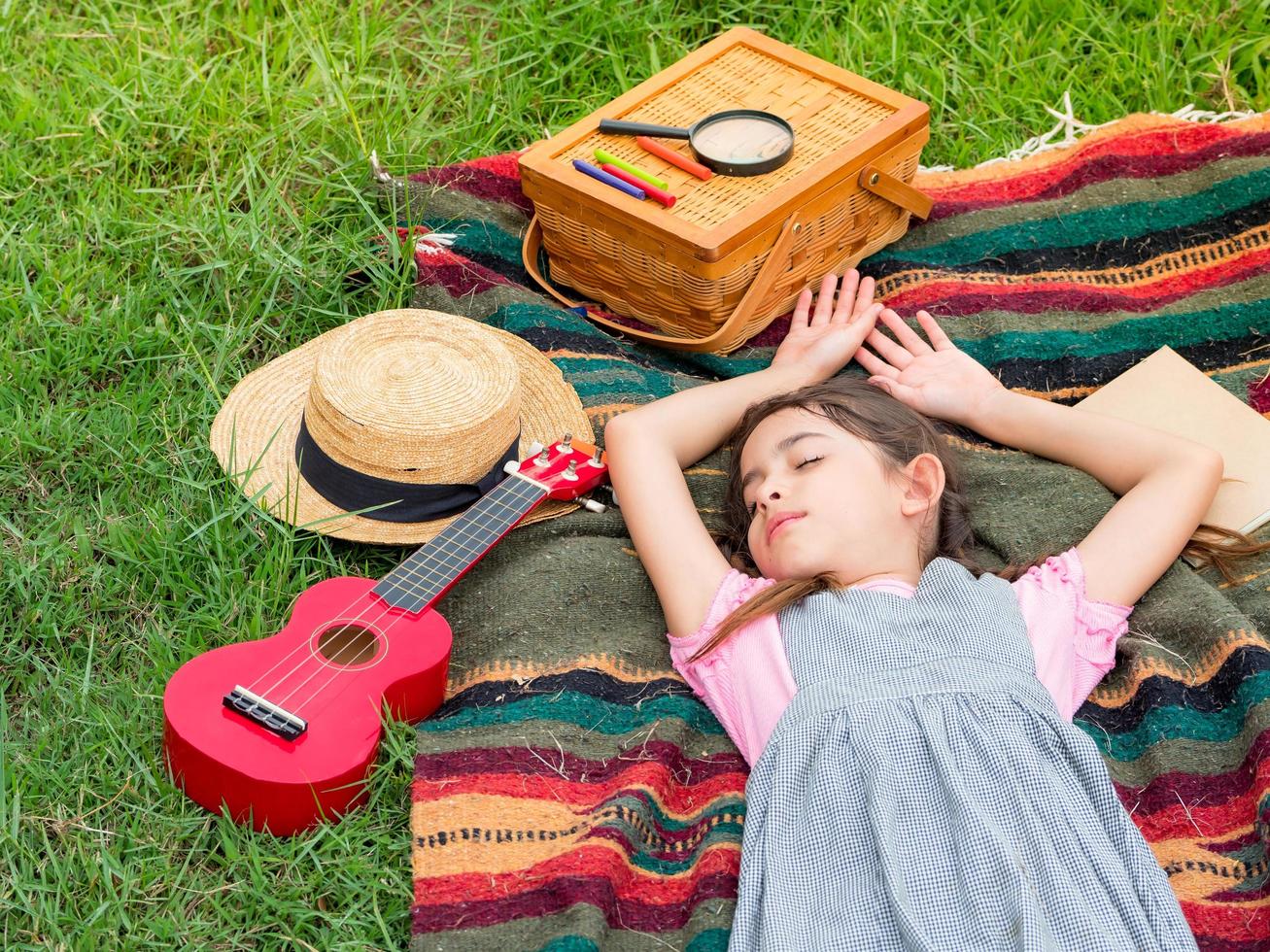 A cute girl sleeps on a blanket after playing and learning photo